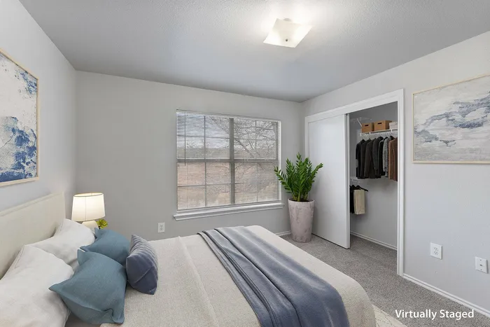 Explore this cozy bedroom in Fort Branch at Truman's Landing in Austin, TX. Featuring modern furniture, natural lighting, and a spacious layout, it’s the perfect retreat for rest and relaxation.