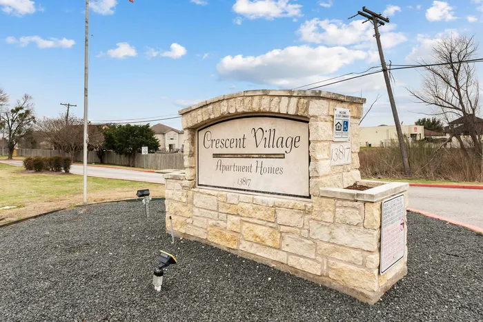 Monument sign at Crescent Village Apartments in Elgin, TX