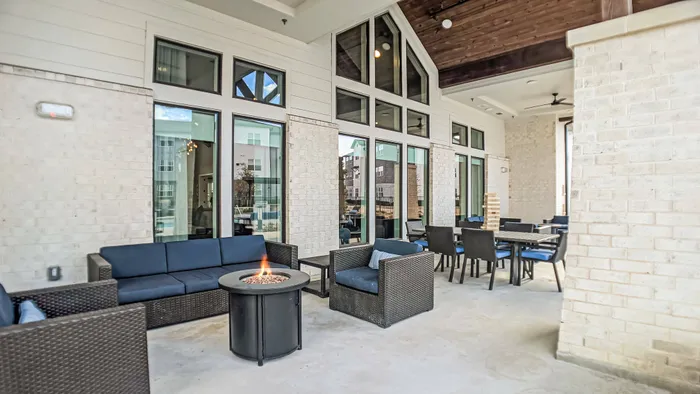 Shaded patio seating and table with elevated firepits