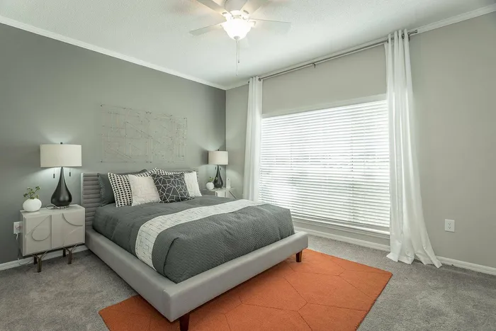 Spacious bedroom with modern furnishings at Avenues of Kennesaw Apartments in Kennesaw, GA