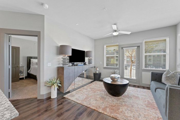 Living room view with open bedroom door and modern decor
