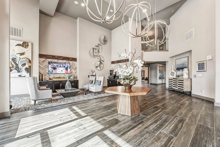 Spacious clubhouse interior with modern decor and large windows at Discovery Park Apartments
