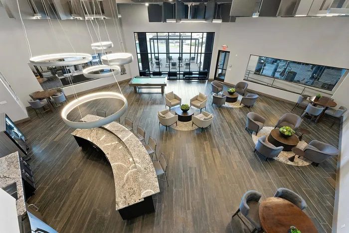 Overhead view of Discovery Park's spacious clubroom with seating areas and curved bar