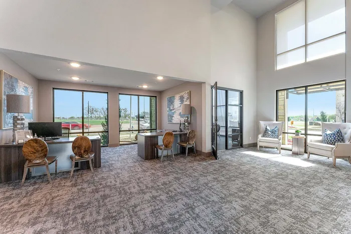 Lounge area with wraparound seating and basketball court view at Discovery Park Apartments in Denton, TX