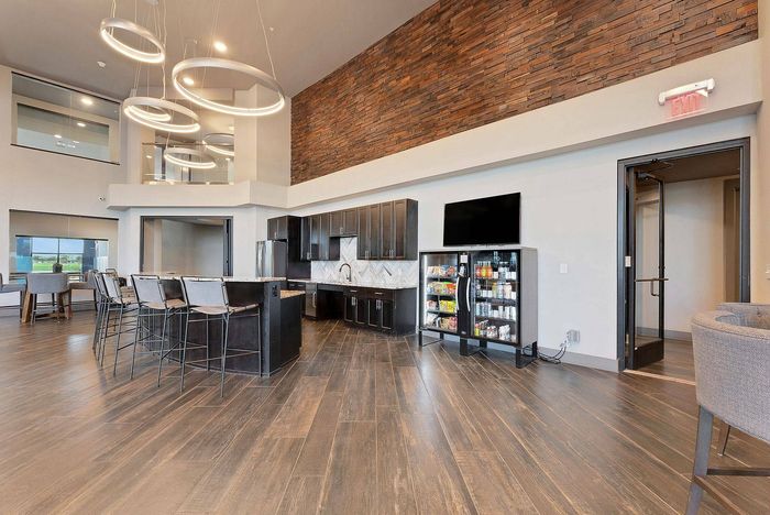 Snack and beverage area with vending coolers and modern cabinetry at Discovery Park Apartments in Denton, TX