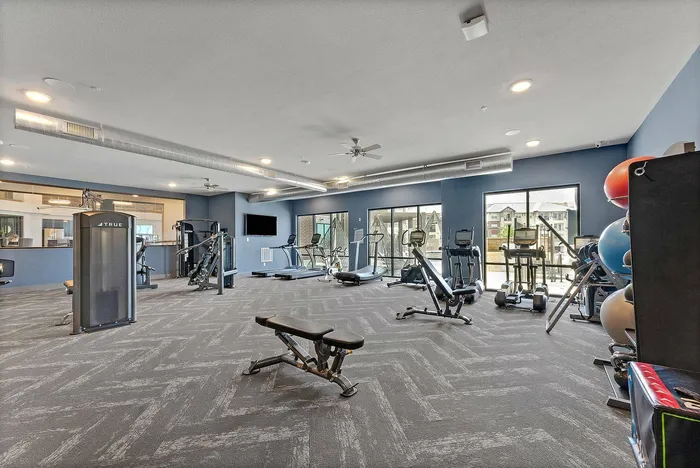 Fully equipped fitness center with cardio and strength machines at Discovery Park Apartments in Denton, TX