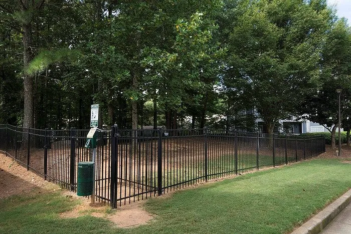Spacious bark park at The Avenues of Kennesaw with agility equipment and shaded seating