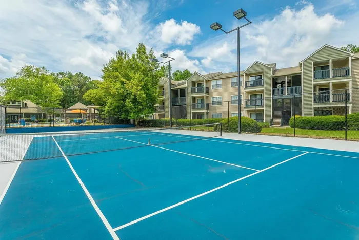 Well-maintained tennis court at Avenues of Kennesaw apartment complex in Kennesaw, Georgia
