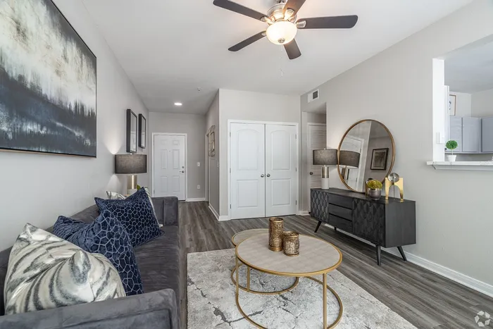 Living room view facing entryway and console cabinet at Towne West Apartments
