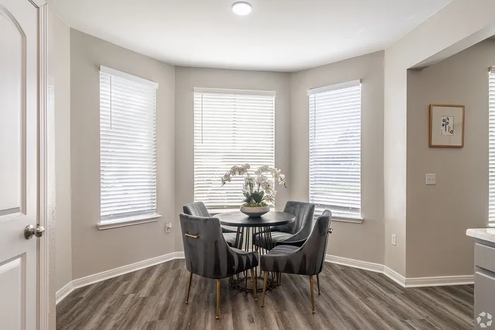 Dining nook with round table and natural light at Towne West Apartments