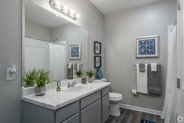 Elegant bathroom with modern finishes and large mirror at Towne West Apartments