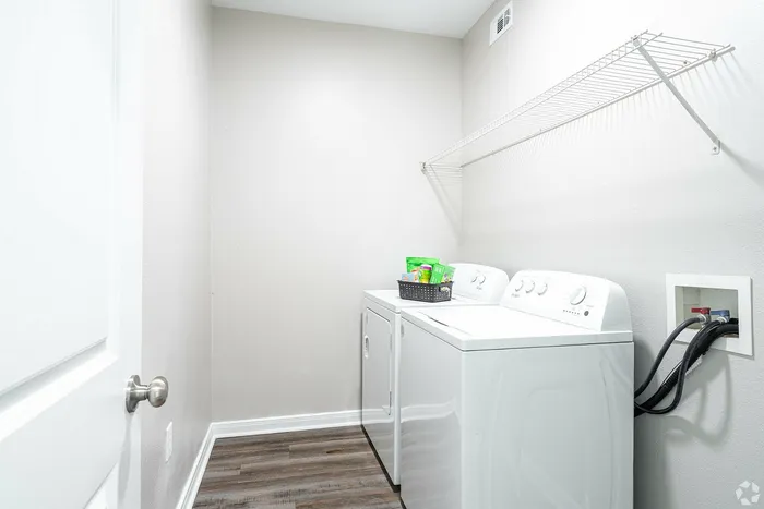In-unit laundry room with washer and dryer at Towne West Apartments