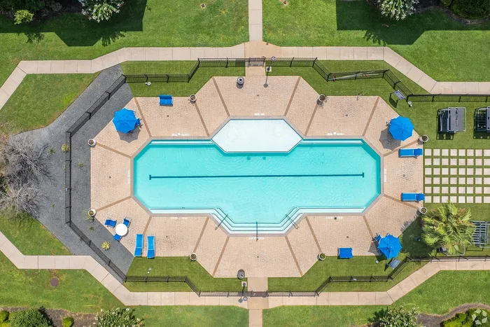 Aerial view of resort-style pool and sundeck at Towne West Apartments