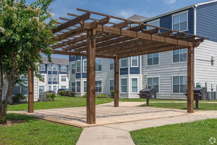 Wooden pergola with grill station at Towne West Apartments in Houston, TX