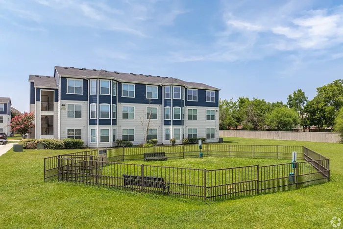 Fenced dog park with benches at Towne West Apartments