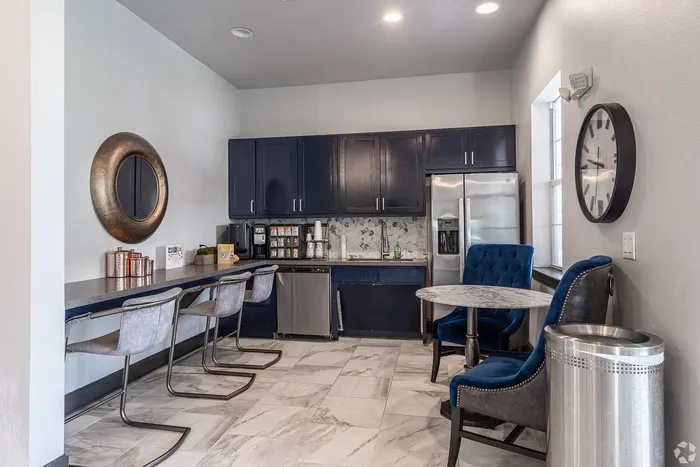 Coffee bar and kitchen area with seating at Towne West Apartments