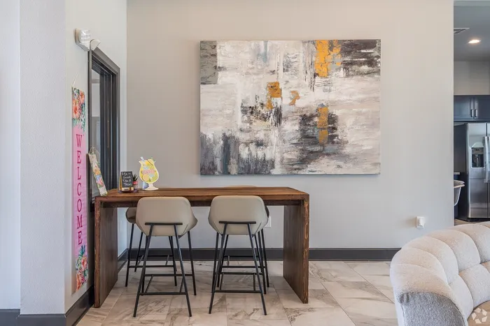 Resident workspace at Towne West Apartments with tall chairs and artwork