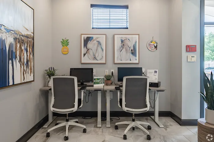 On-site business center at Towne West Apartments with computers and chairs