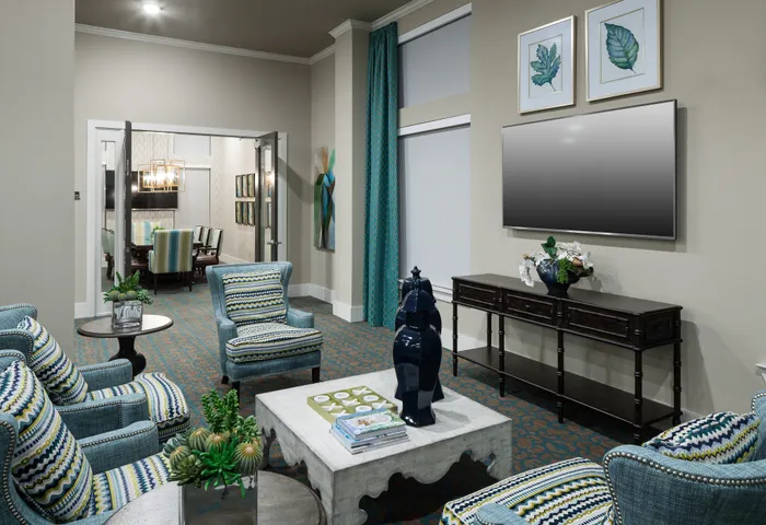 Clubroom with lounge chairs and TV at McDermott 55