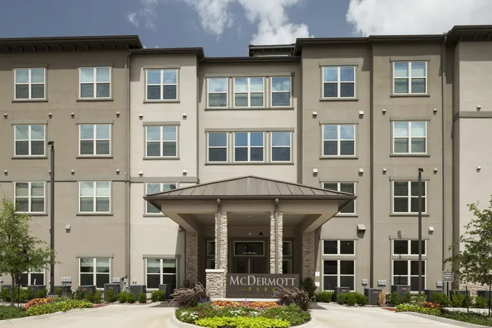 Exterior view and sign of McDermott 55 senior living in Plano