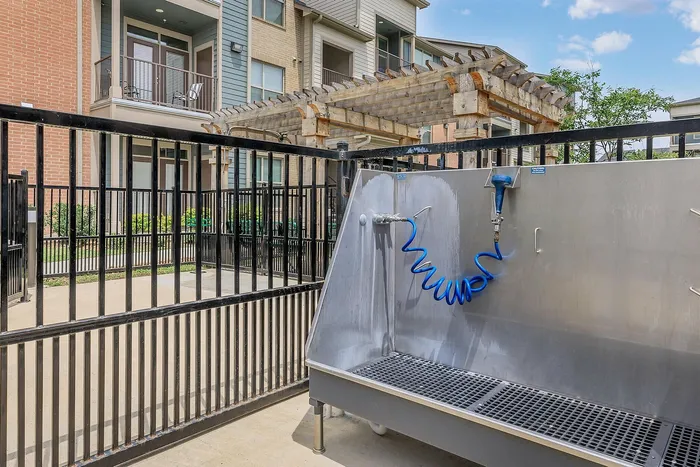 Modern pet wash station with tiled walls and sprayers at Cityscape Apartments in Houston