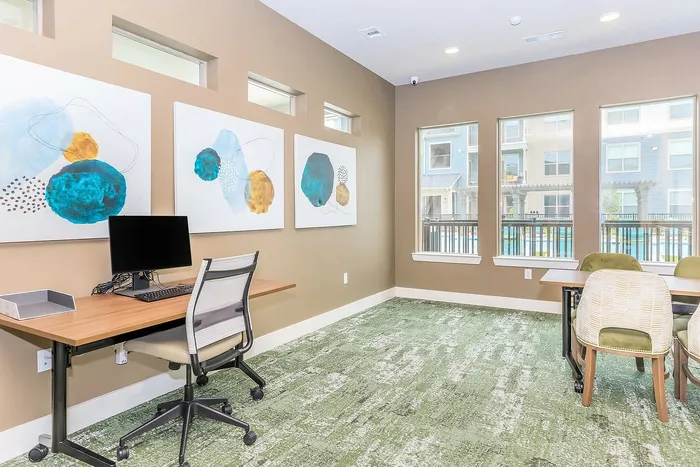 Sleek business center with desks, chairs, and computers at Cityscape Apartments, Houston