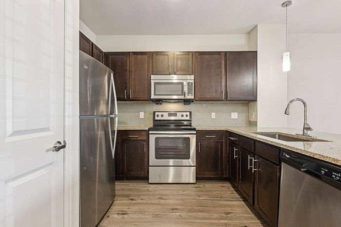 Elegant kitchen with granite island and stainless steel appliances at Allora Bella Terra