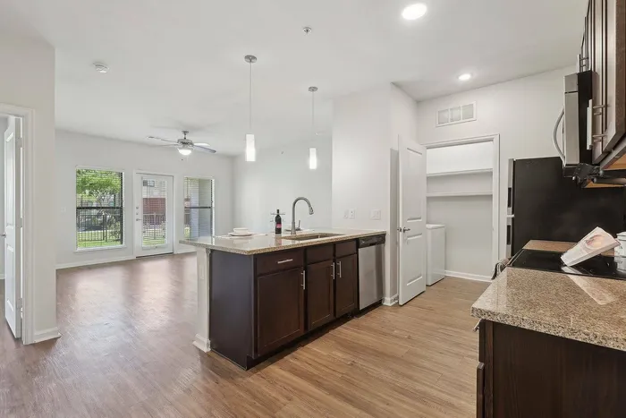 Spacious open-concept kitchen and living area with island and natural light at Allora Bella Terra