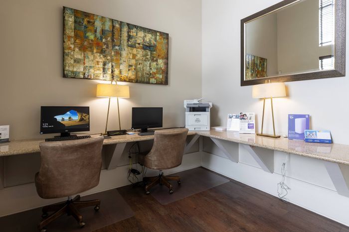 business center with hardwood floors, chairs, and computers