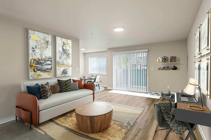 Bright living and dining area with vaulted ceilings and hardwood‑style flooring at Foster Creek Tukwila