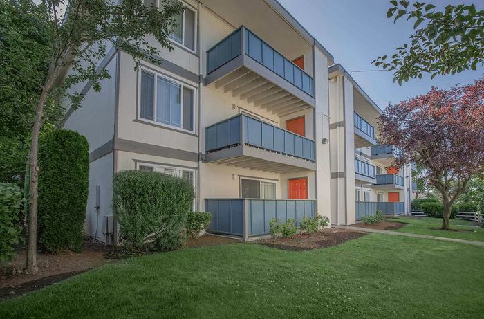 Foster Creek Apartments building exterior with landscaped green space in Tukwila WA
