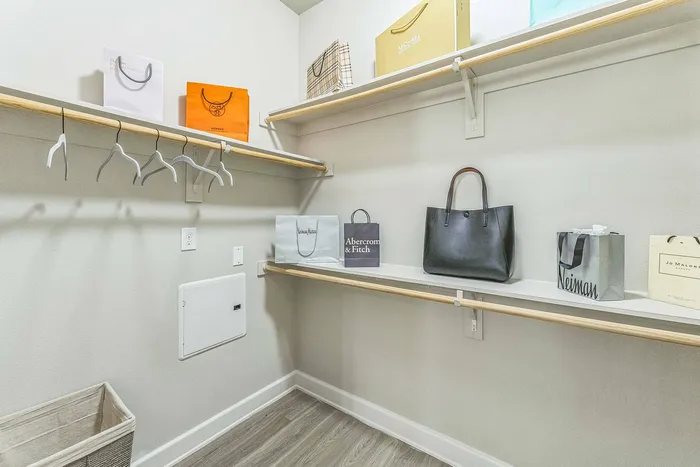 Large walk-in closet with built-in shelves at Addison Keller Springs, Addison, TX