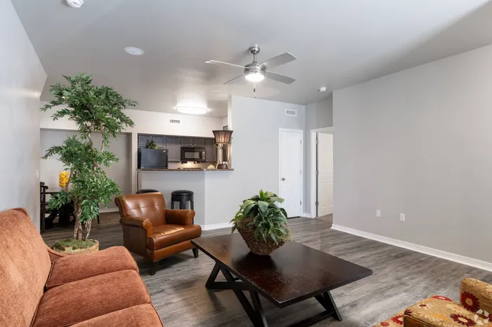 Beautifully decorated living room with vibrant seating, a coffee table, and warm accents at Lifestyles Hueco Estates in El Paso, TX.