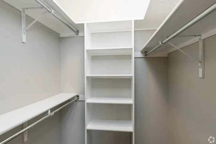 Spacious walk-in closet with built-in shelving and ample hanging space at Lifestyles Hueco Estates in El Paso, TX.