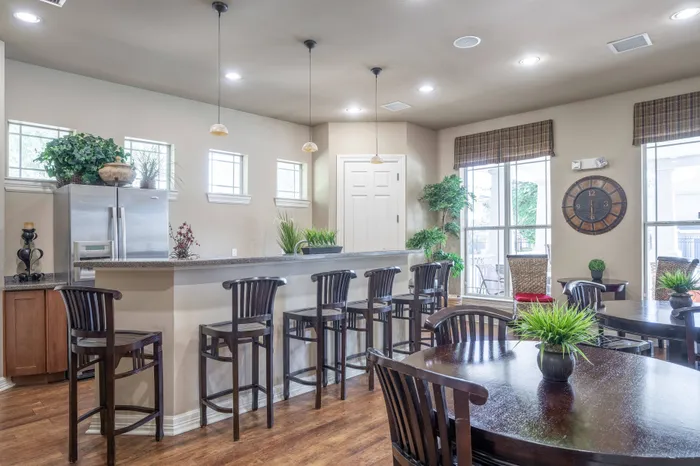 Elegant clubhouse at Lifestyles Hueco Estates in El Paso, TX, featuring cozy leather seating, a grand fireplace, and warm, inviting decor.