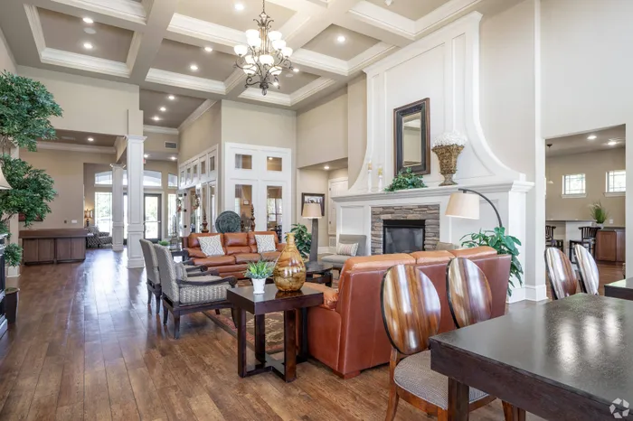 Elegant clubhouse at Lifestyles Hueco Estates in El Paso, TX, featuring cozy leather seating, a grand fireplace, and warm, inviting decor.