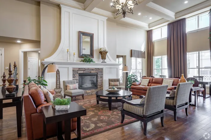 Elegant clubhouse at Lifestyles Hueco Estates in El Paso, TX, featuring cozy leather seating, a grand fireplace, and warm, inviting decor.