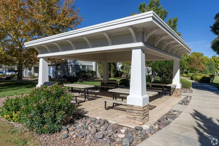 Covered outdoor picnic area with BBQ grills at Lifestyles Hueco Estates in El Paso, TX.