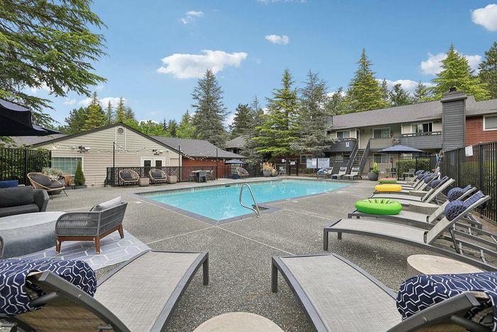sparkiling pool with plentiful lounge seating at The Ardent