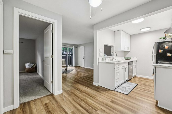 spacious living area with wood inspired flooring at The Ardent