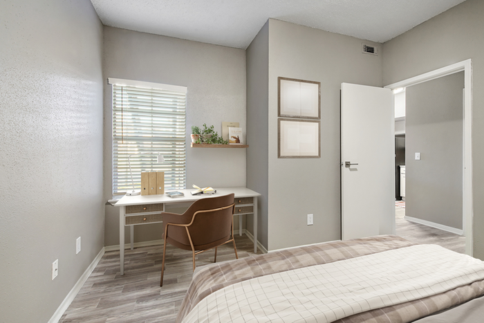 Bedroom with desk and cair near window