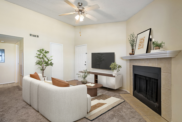 Living room with ceiling fan, couch and TV