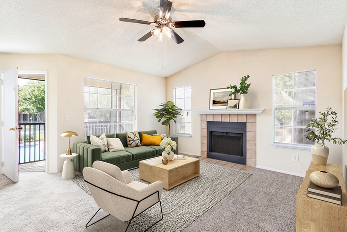 Living room with ceiling fan, fire place, and furniture