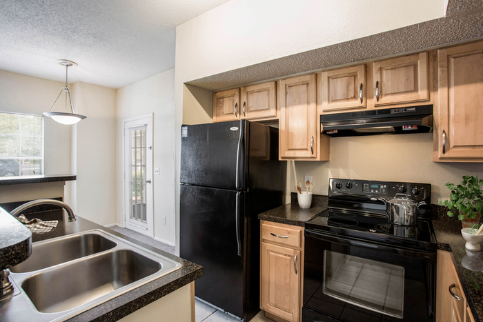 Kitchen with black appliances and wood cabinets