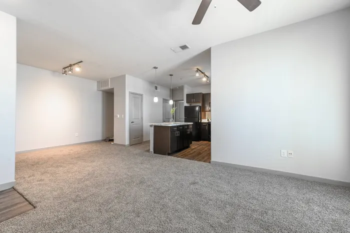 spacious living area with ceilng fan and carpeting at Encore Crossing