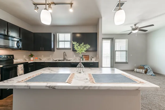 kitchen island open to living area with seating