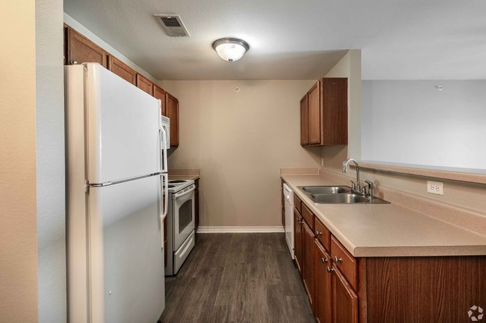 Contemporary kitchen with stainless steel appliances and granite countertops at Inwood Crossings in Wichita, Kansas.