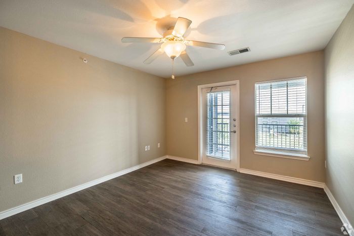 Comfortable living room with neutral decor and ample space at Inwood Crossings in Wichita, Kansas.