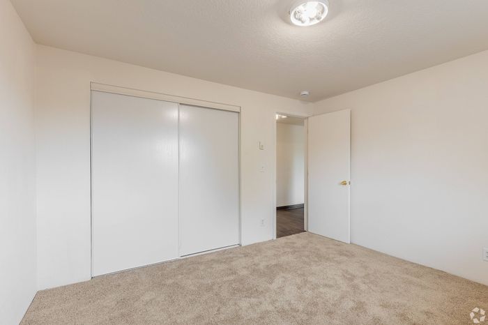 Spacious bedroom with large window at Fox Pointe Apartments in Portland, OR