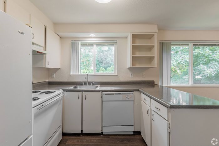 Modern kitchen with stainless steel appliances at Fox Pointe Apartments in Portland, OR